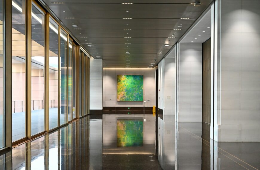Modern hallway with abstract art and glass walls
