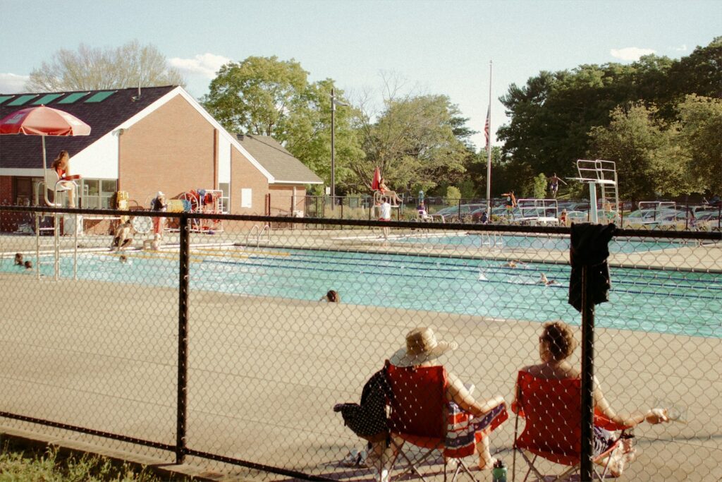 people sitting on bench near body of water during daytime