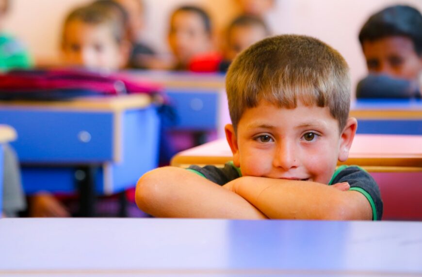A group of children sitting at desks in a classroom