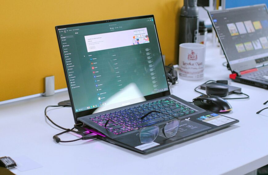 a laptop computer sitting on top of a white desk