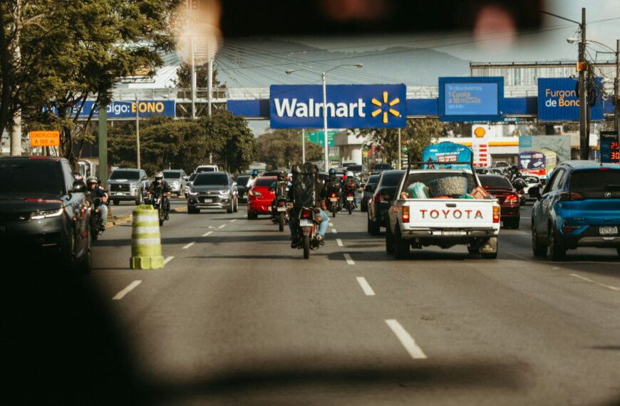 Busy road traffic passes a walmart store.