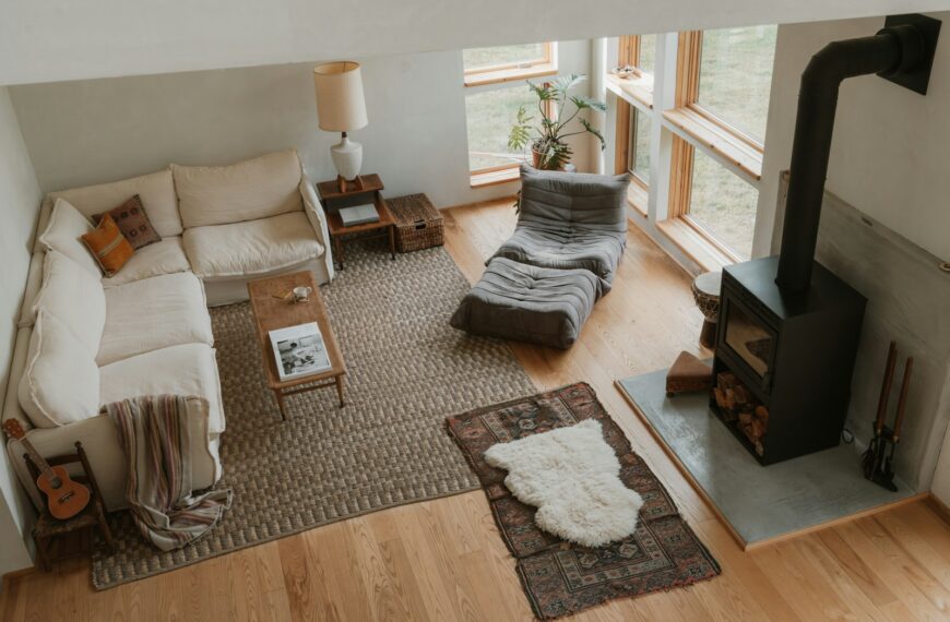 Cozy living room with sectional sofa and wood stove.