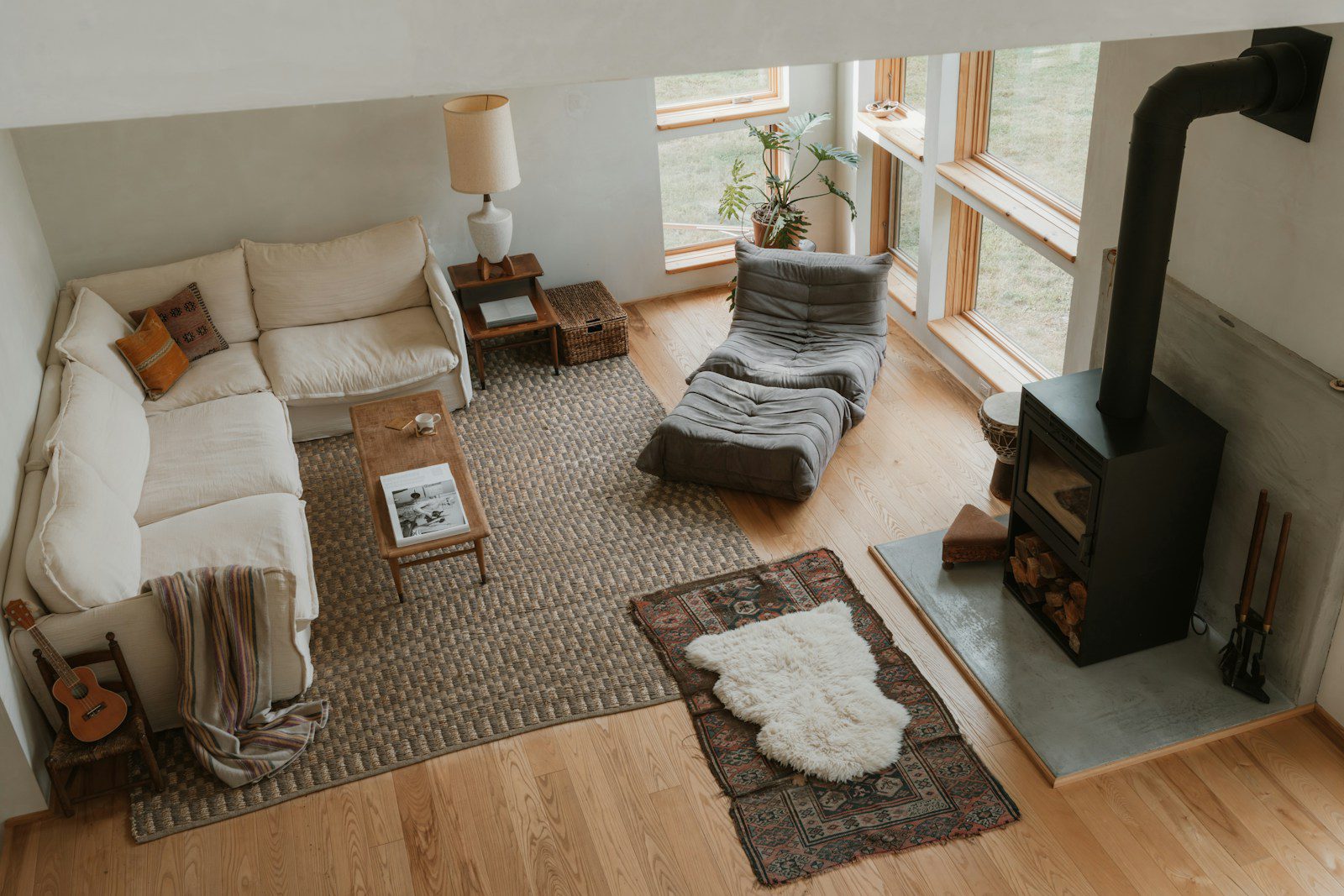 Cozy living room with sectional sofa and wood stove.