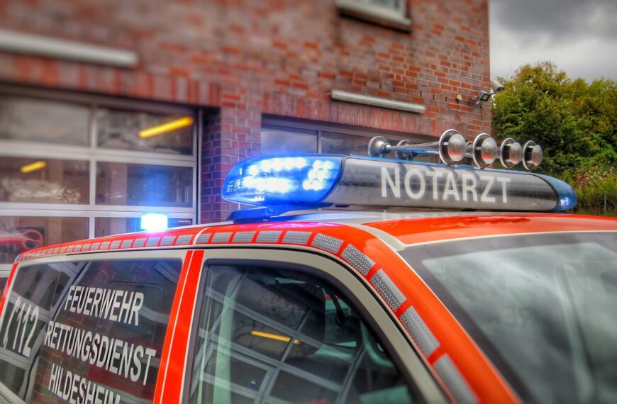 an orange police car parked in front of a building