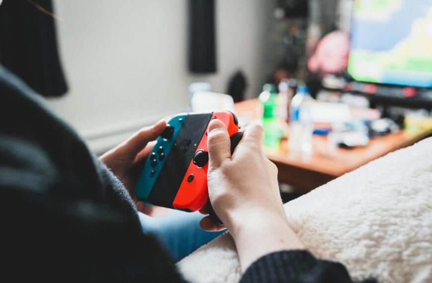 person holding orange and black device