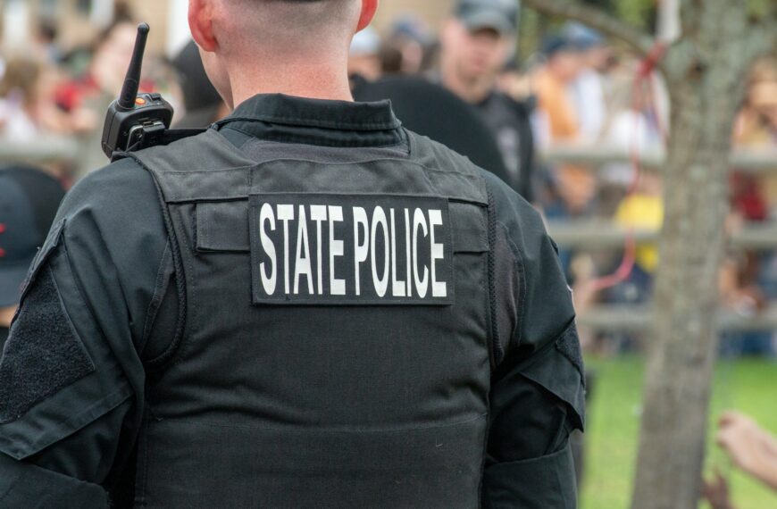 person wearing black State Police vest