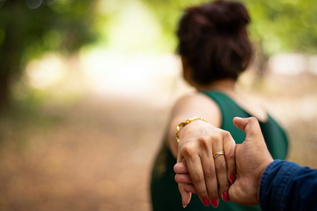 A person holds a hand and leads the way.