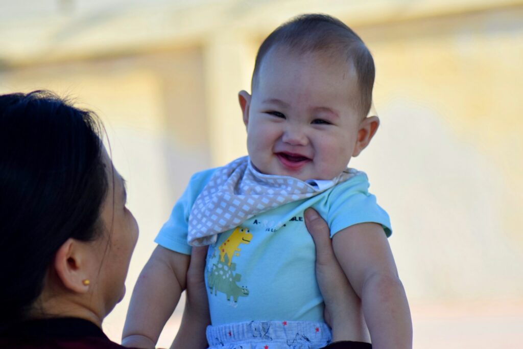 A woman holding a baby up to her face