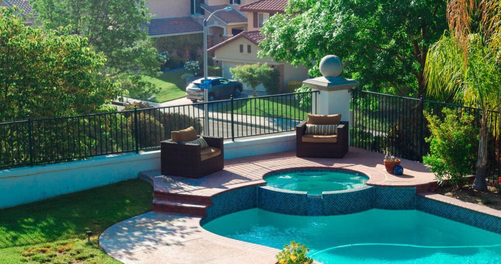 blue swimming pool near green trees during daytime