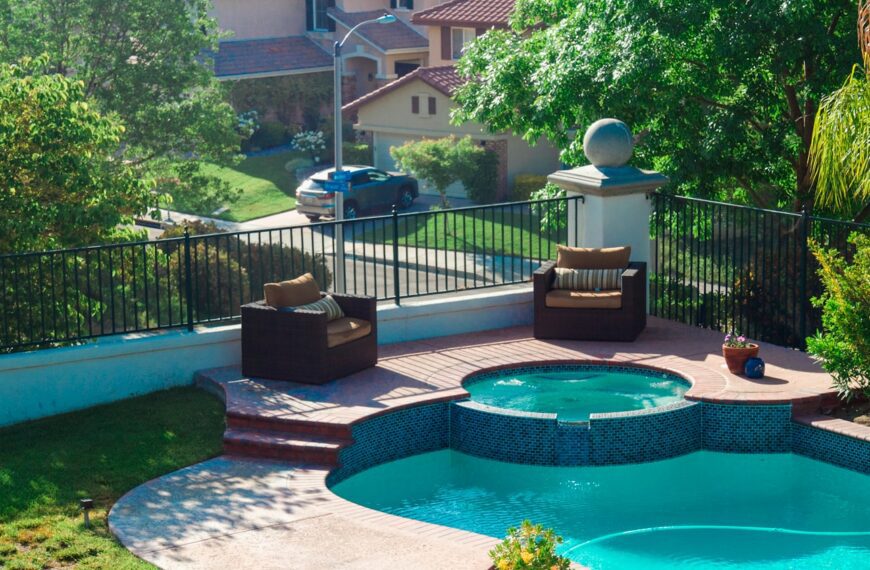blue swimming pool near green trees during daytime