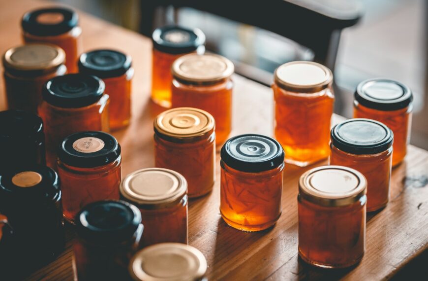 a table topped with lots of jars filled with liquid