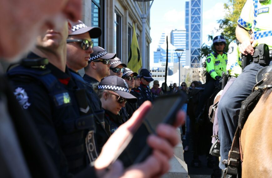man in black police uniform holding black smartphone