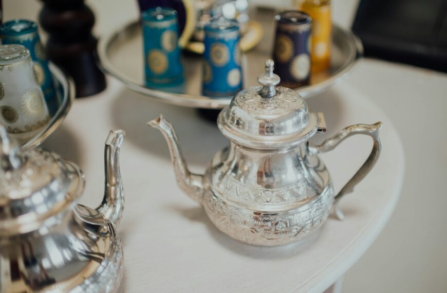 stainless steel teapot on clear glass tray