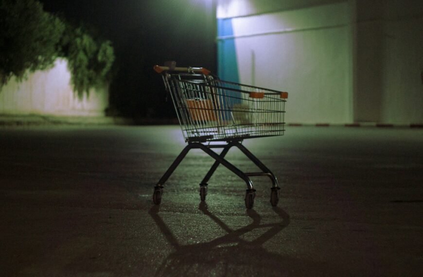 Shopping cart on wet pavement at night