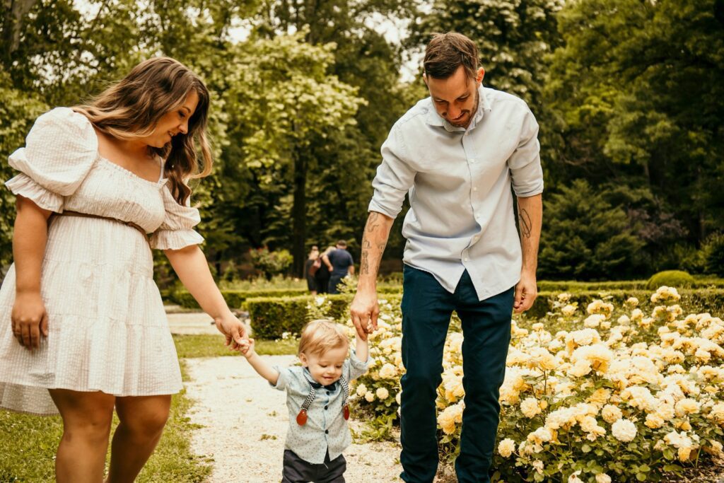 a man holding the hand of a little boy