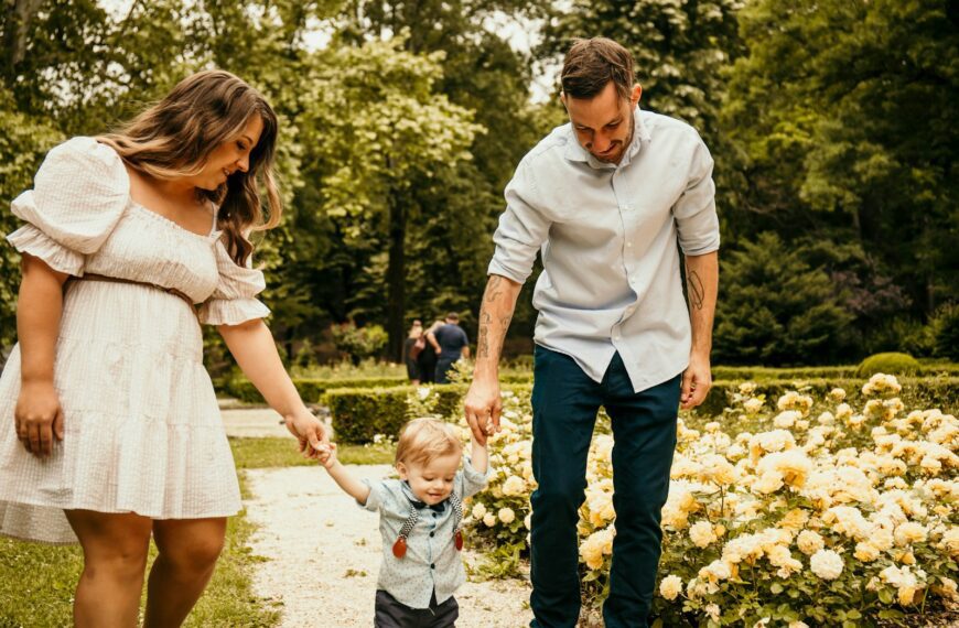 a man holding the hand of a little boy