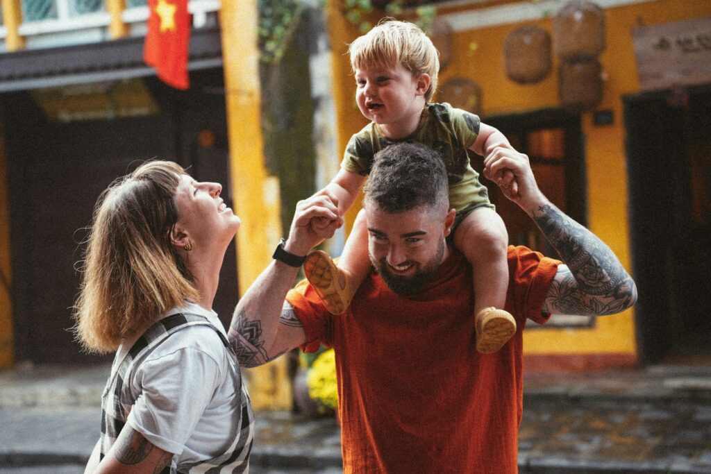 a man holding a young boy on his shoulders