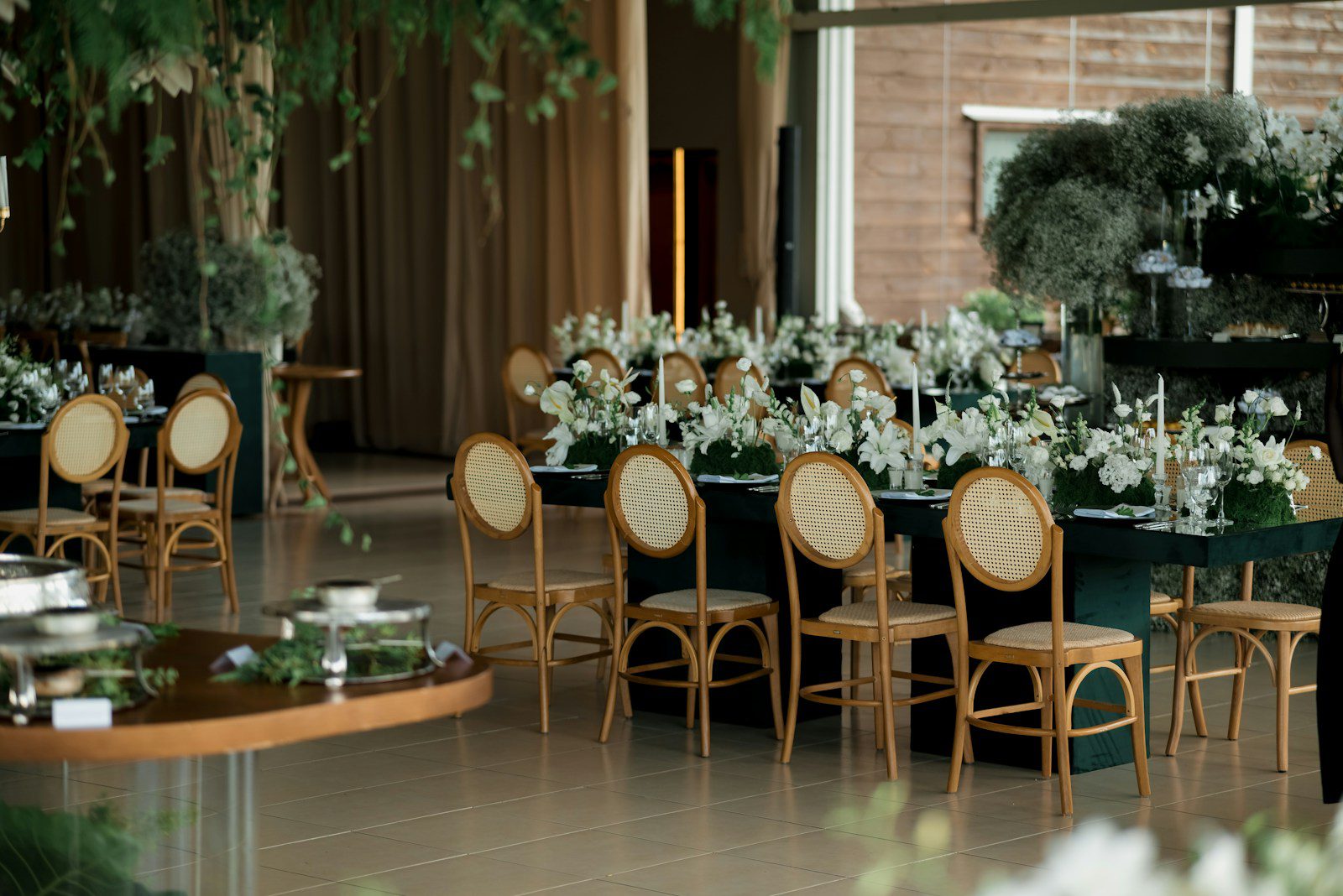 Elegant event tables set with white flowers and chairs