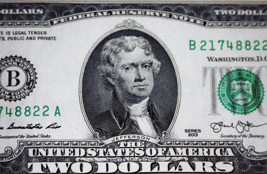 us dollar bill on black and white textile