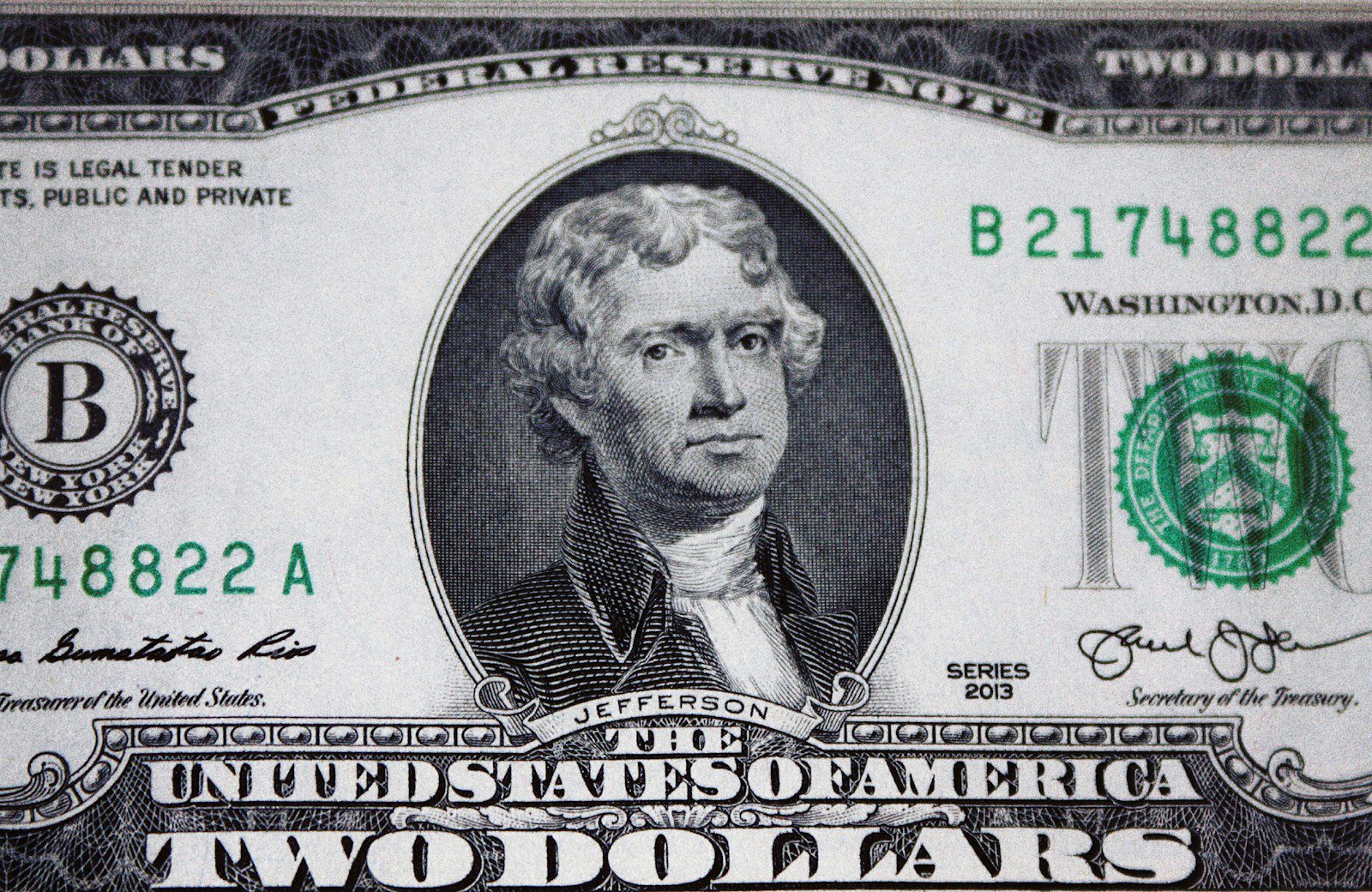 us dollar bill on black and white textile