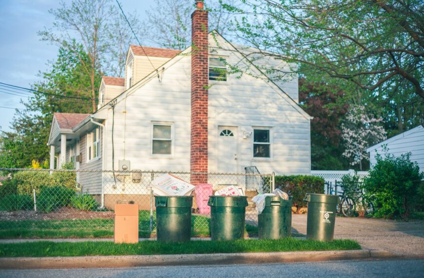 white and red concrete house near trees during daytime
