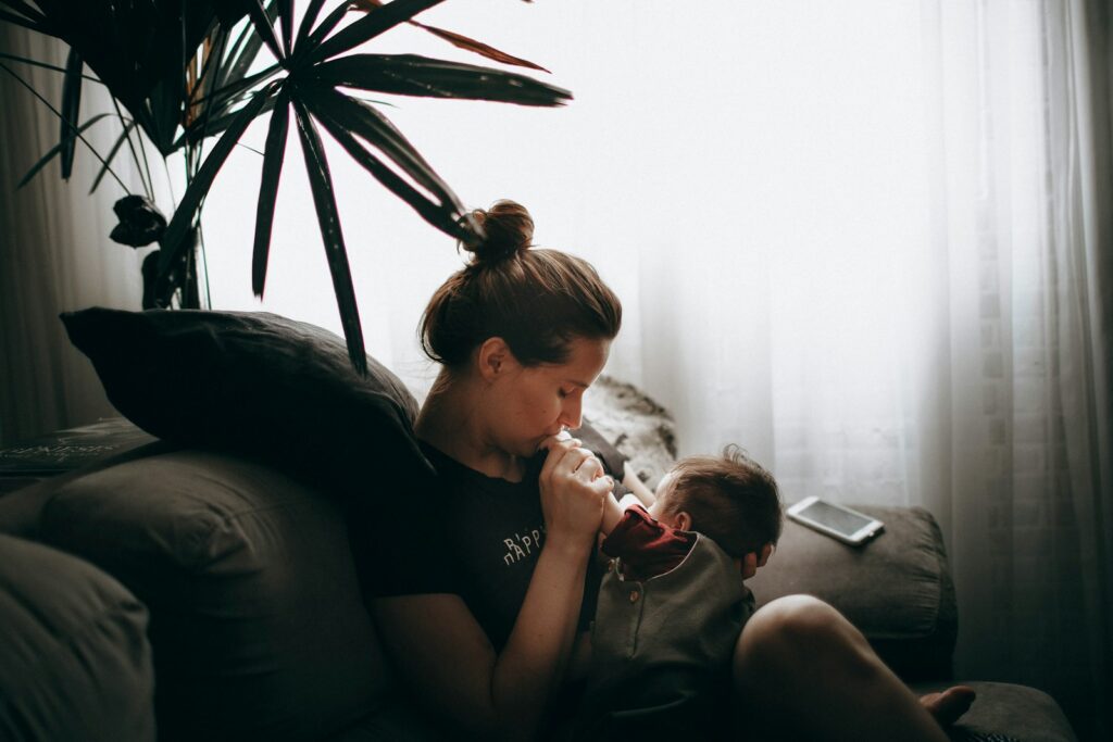 woman in black t-shirt sitting on couch