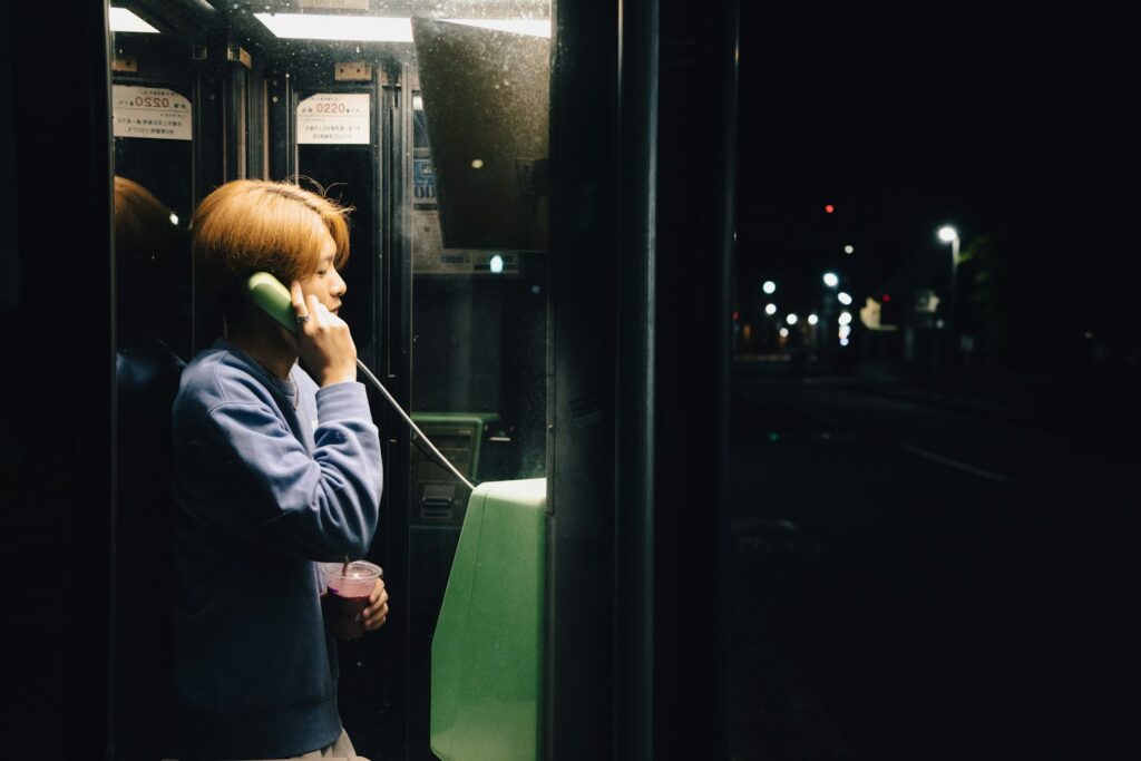 A woman talking on a cell phone while riding a bus