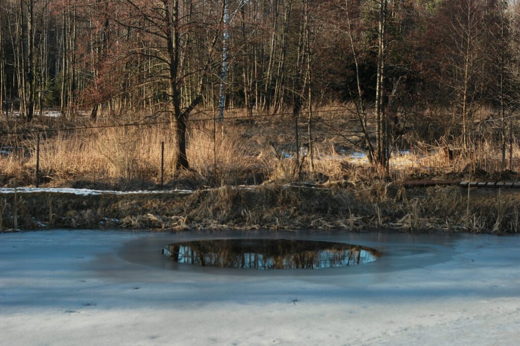 Ice melts, creating a hole with reflection.