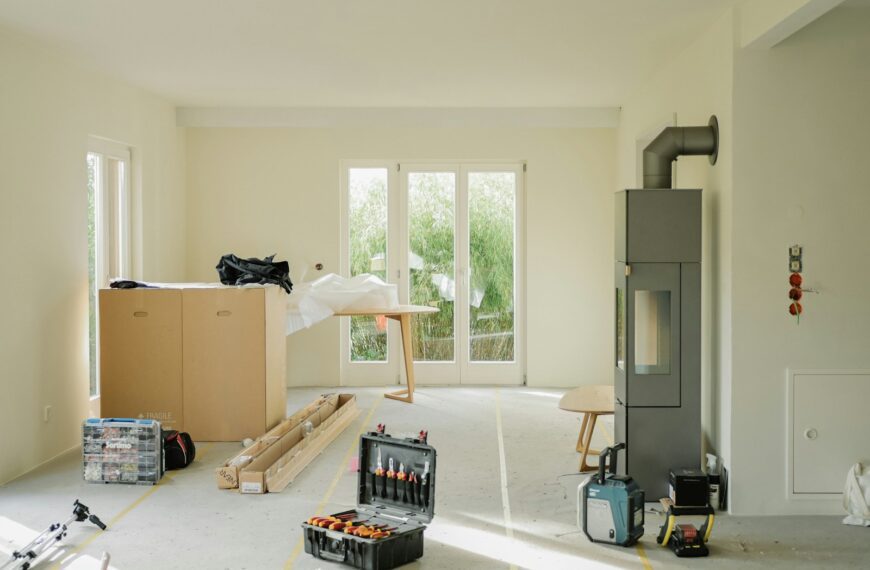 Room under renovation with tools and furniture.