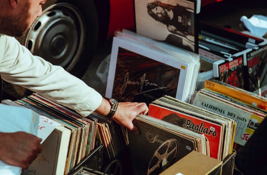 person holding vinyl records
