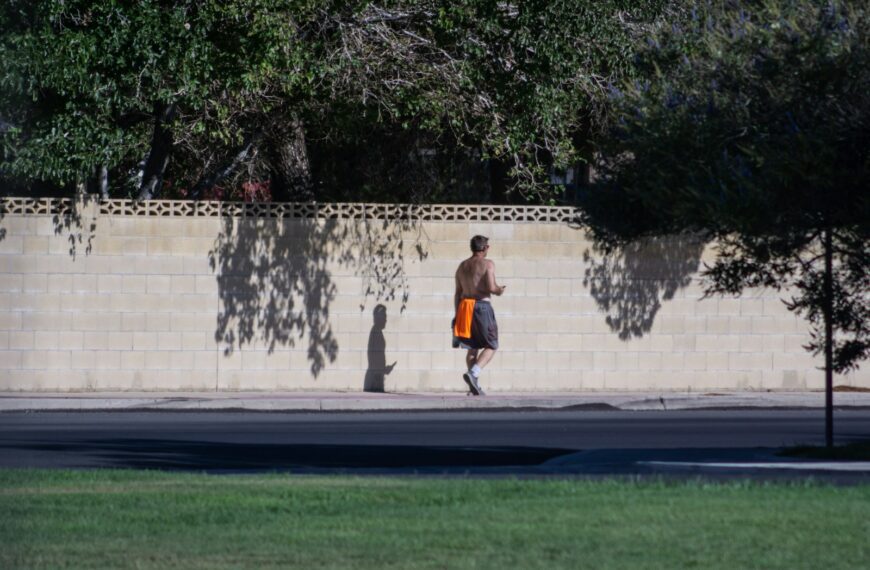 a man running on a sidewalk