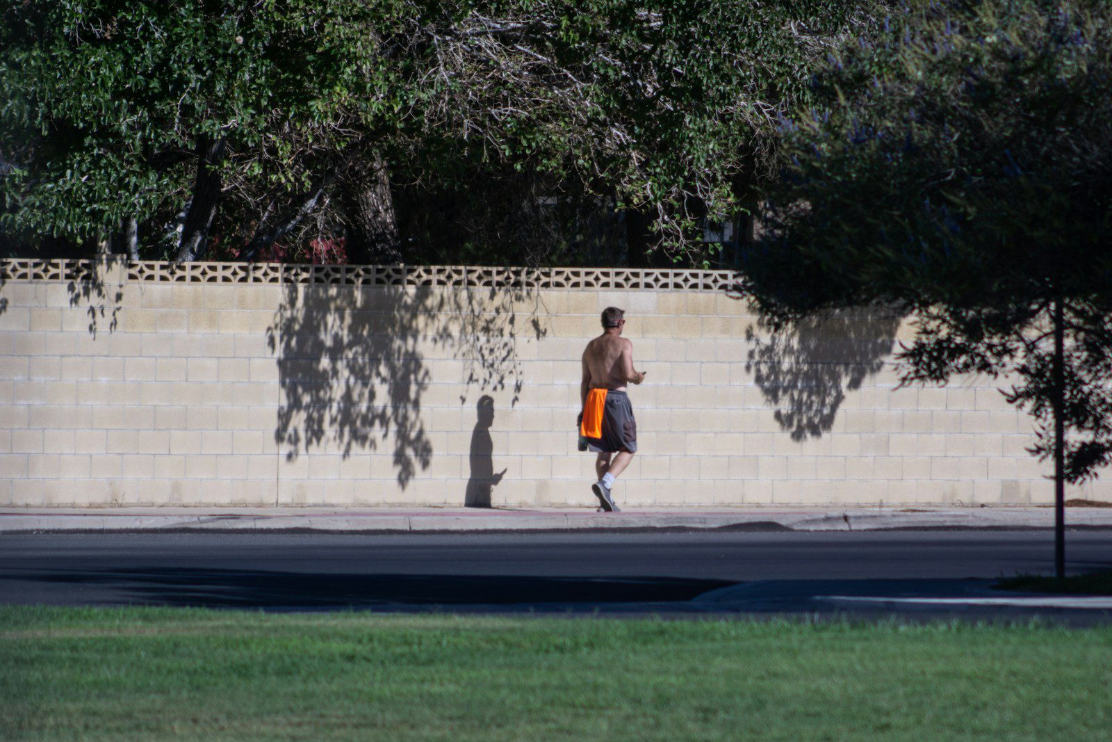 a man running on a sidewalk