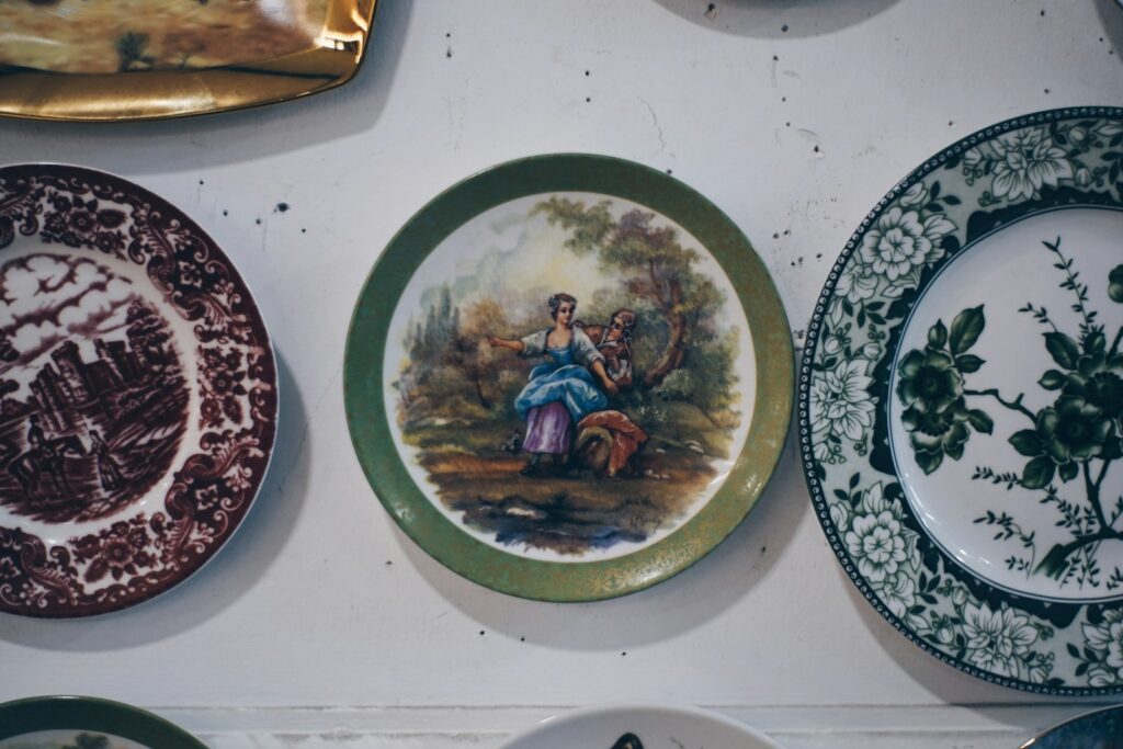 Collection of decorative plates with painted scenes.