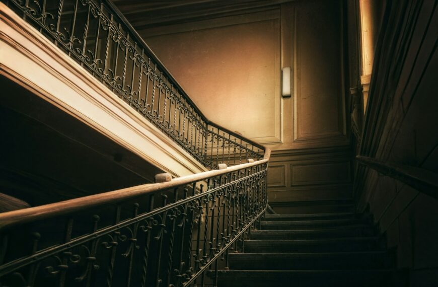 A dark, ornate staircase with a vintage feel