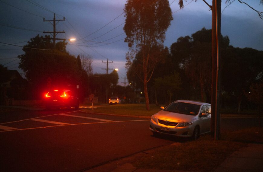 a car stopped at a red light at night