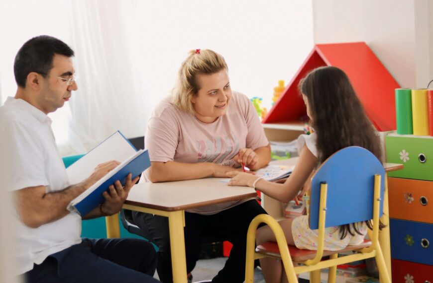 A group of people sitting around a table in a room