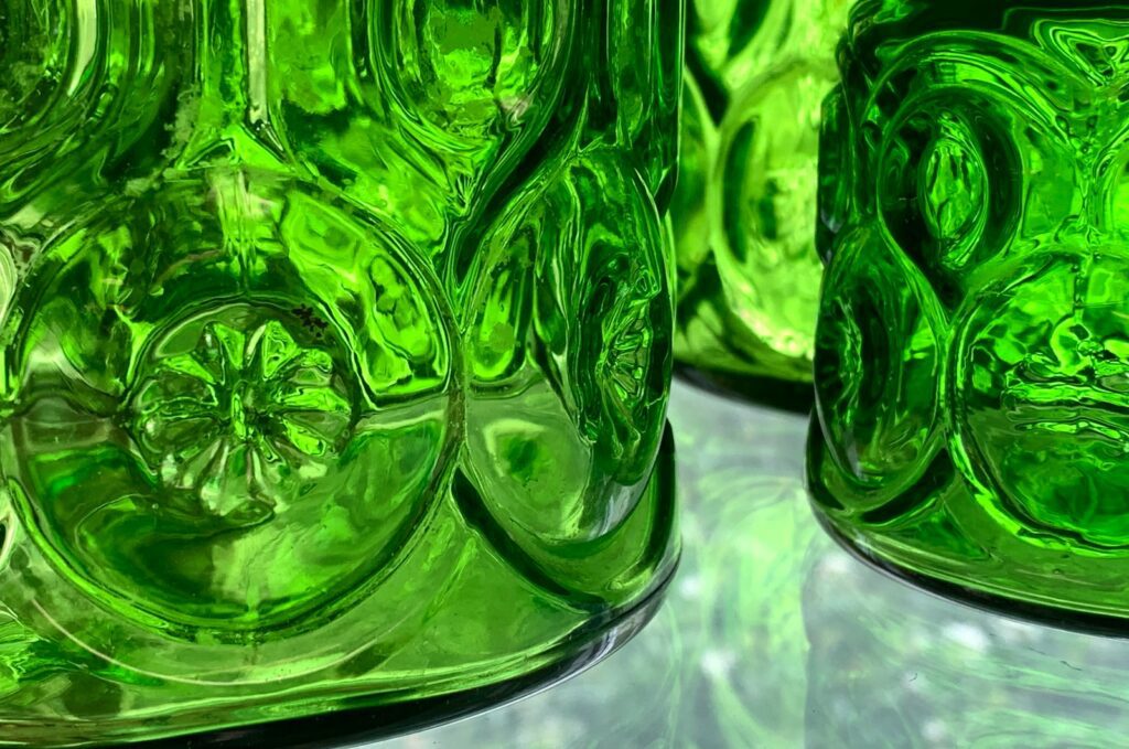 a close up of a green glass vase