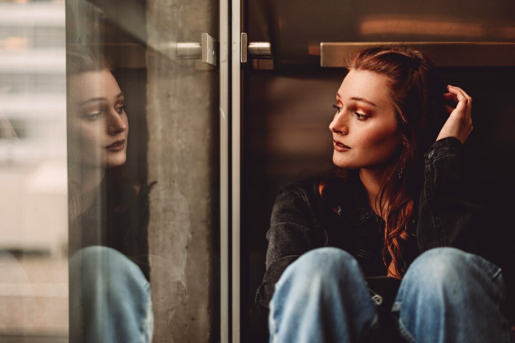 woman in blue denim jacket sitting on chair