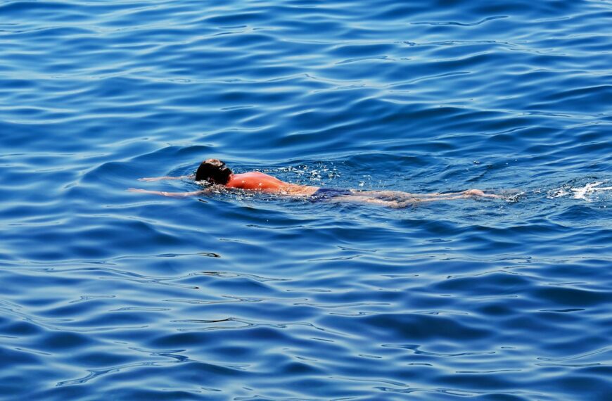 Person swimming in the blue ocean water