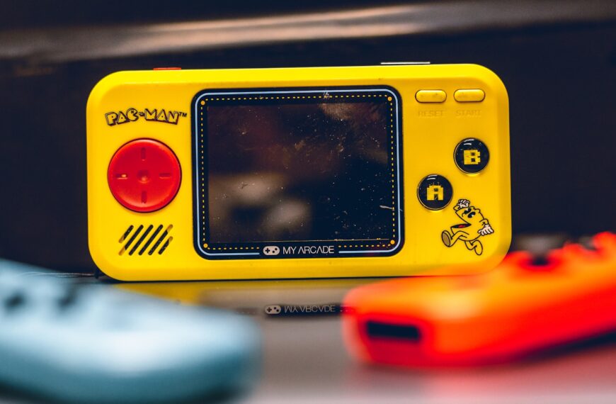 a yellow gameboy sitting on top of a table