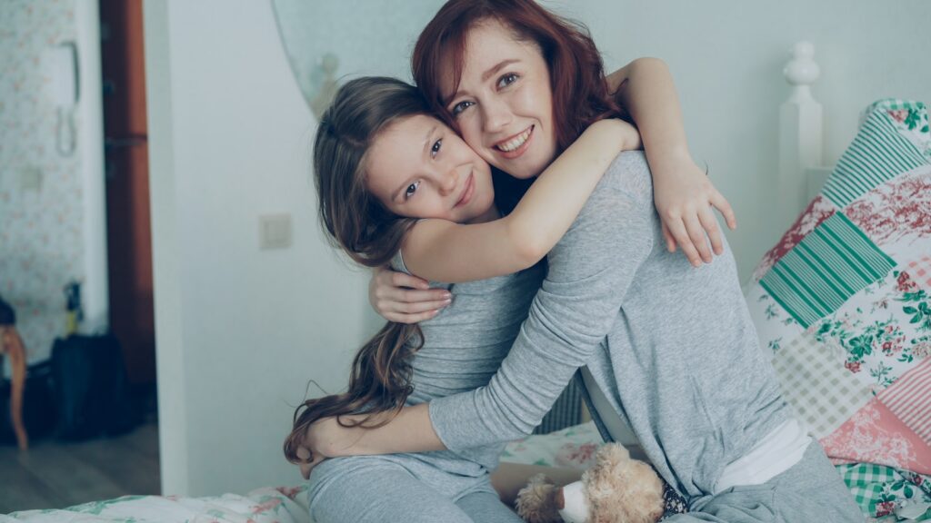 Mother and daughter share a warm, loving hug.