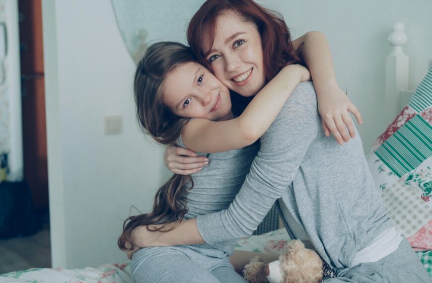 Mother and daughter share a warm, loving hug.