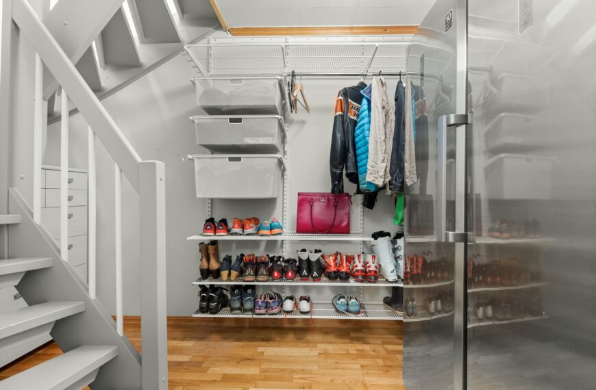 A walk in closet with a lot of shoes