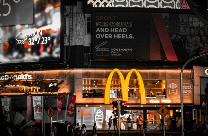 a large sign hangs over a street