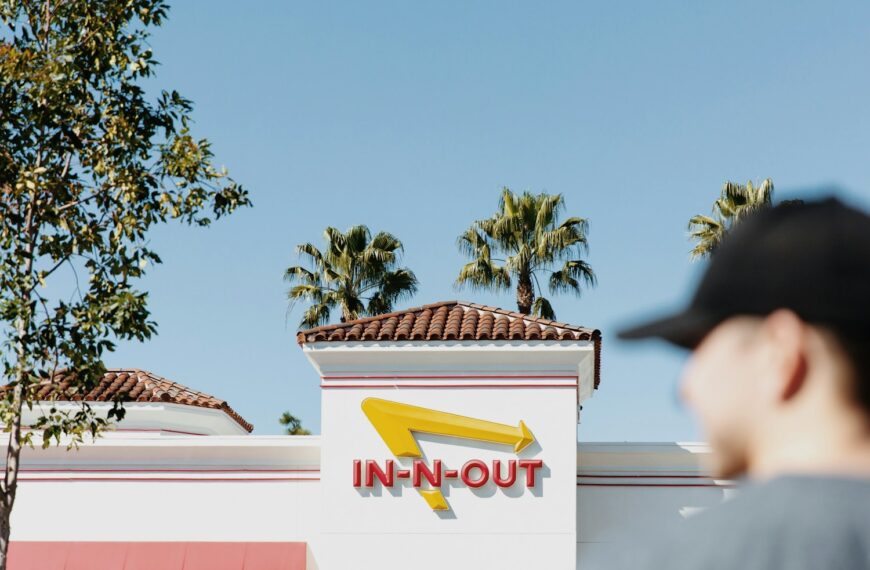 a man standing in front of a fast food restaurant