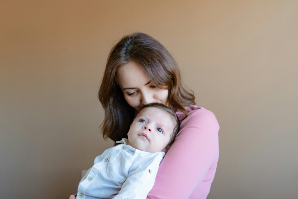 a woman holding a baby in her arms