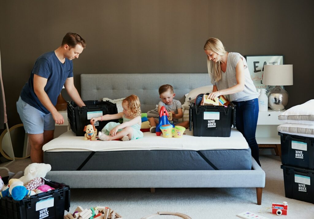 man in blue crew neck t-shirt standing beside woman in white long sleeve shirt