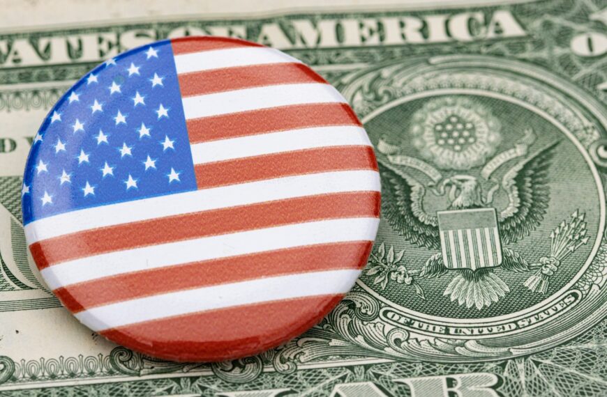 a button with the american flag on top of a dollar bill
