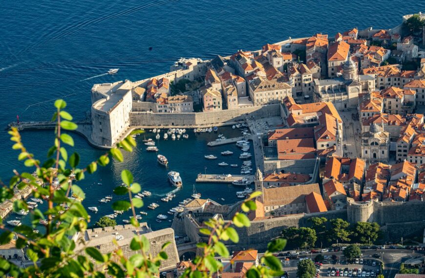 aerial view of city buildings near body of water during daytime