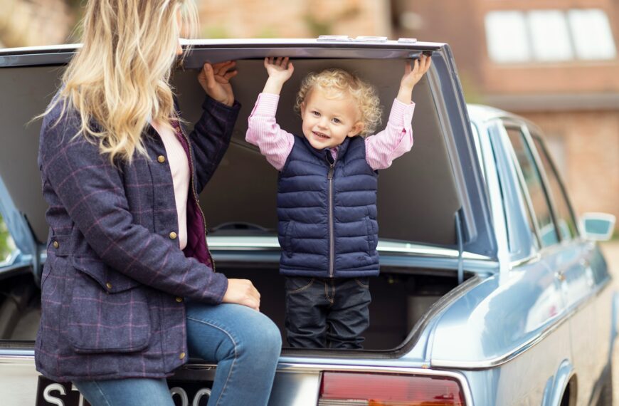 a woman and a child sitting in the back of a car